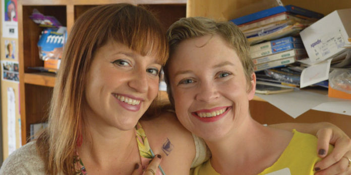 Molly-Raynor,-left,-pictured-here-with-Neutral-Zone-alum-Evelyn-Hollenshead,-started-in-the-Literary-Arts-Program-as-a-student-when-she-was-14-years-old_ Image of Molly Raynor and her Neurtal Zone alum Evelyn Hollenshead