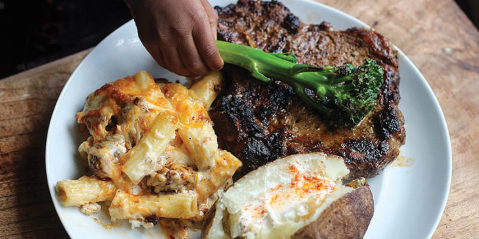 food1 Steak, Baked Mac-n-Cheese, and Baked Potato with Brussels Sprout Garnish.
